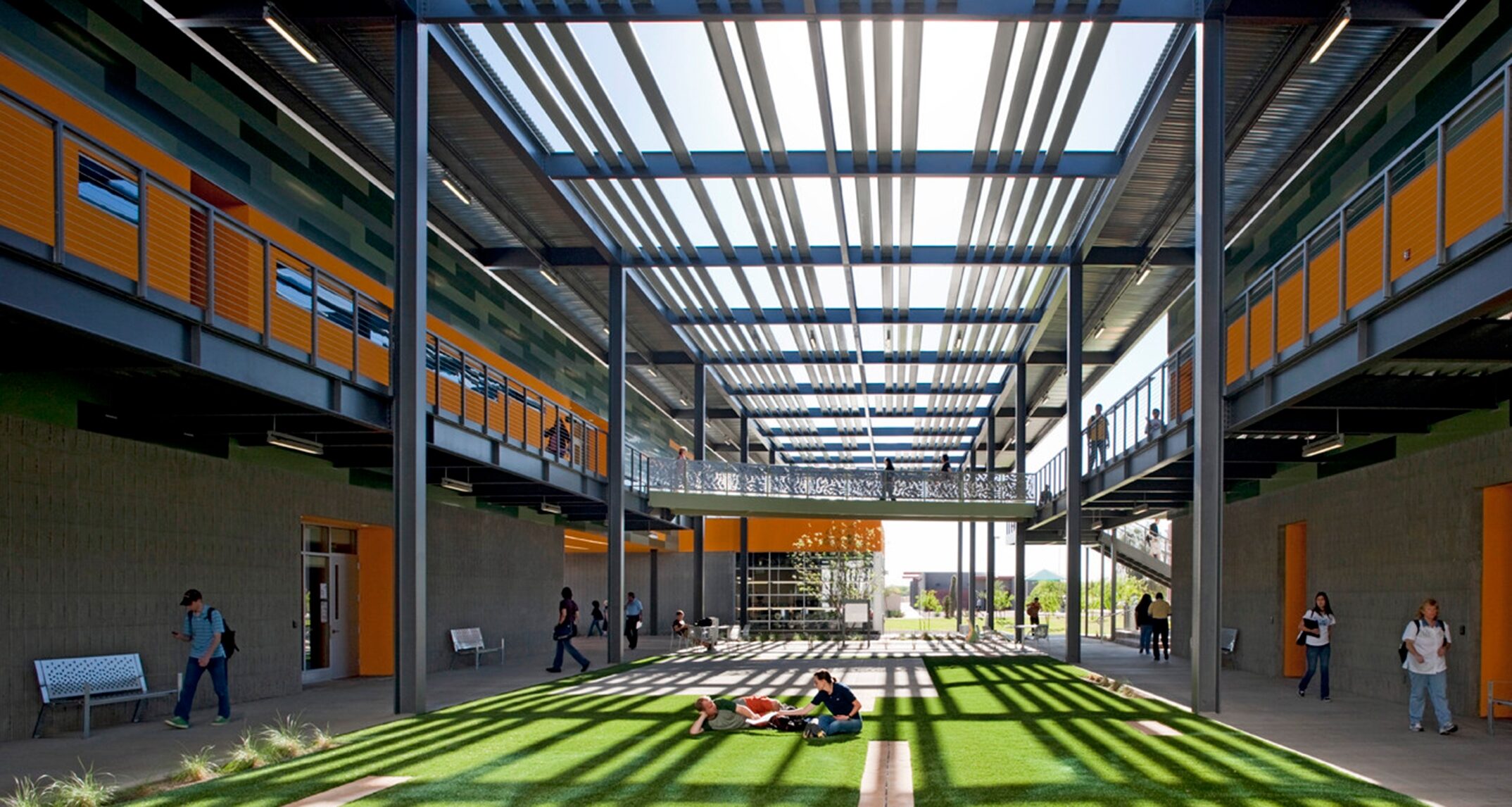 The central plaza at Chandler Gilbert Community College is designed to provide a campus gathering place on a smaller scale. Elevated walkways around the perimeter encourage interaction but the more intimate setting helps students feel sheltered and safe. – Architekton
