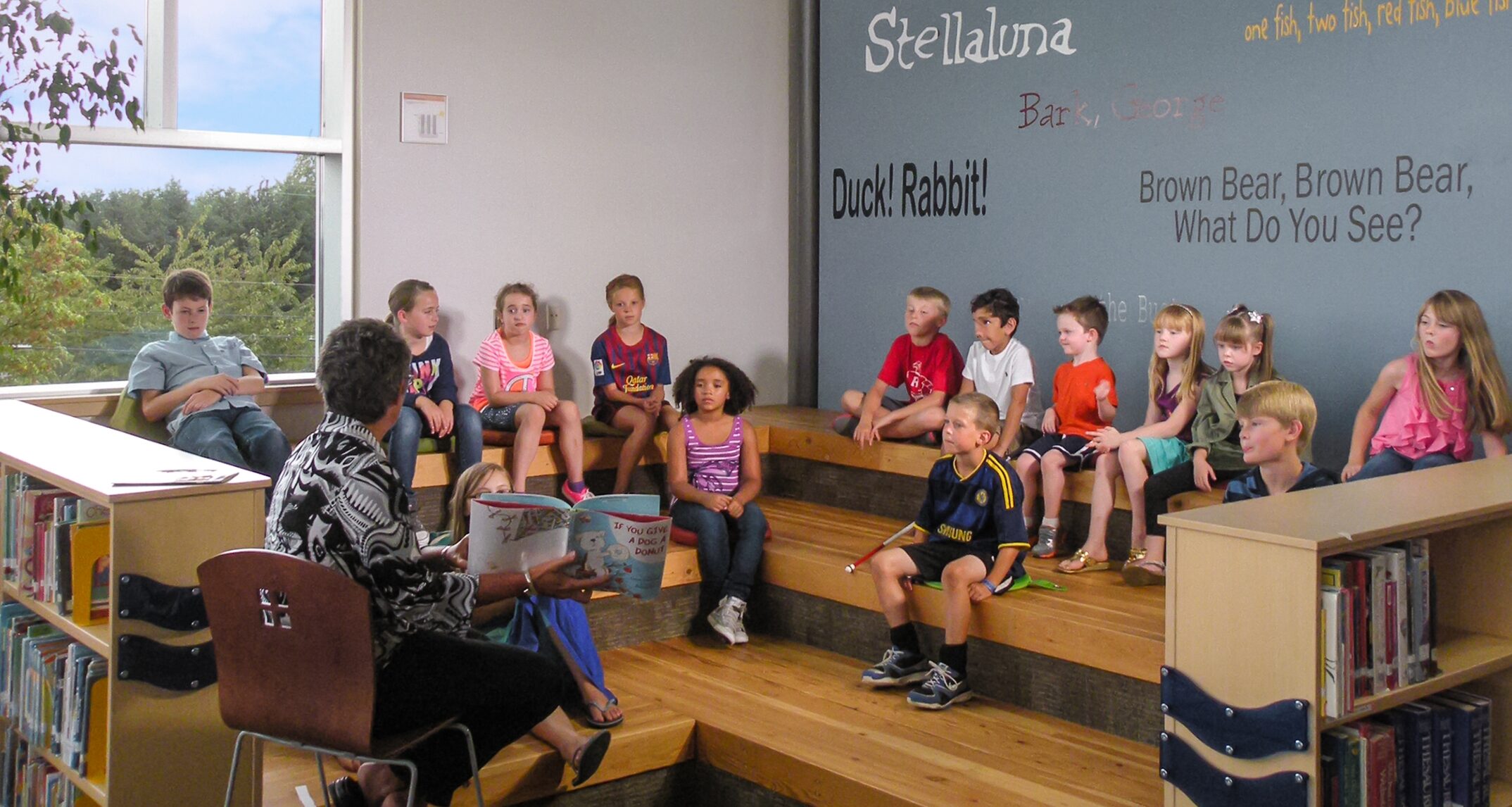 At Riverview Elementary, the group reading area in the library is used by the ELC and parents or senior citizens volunteer to read to early learners. – NAC