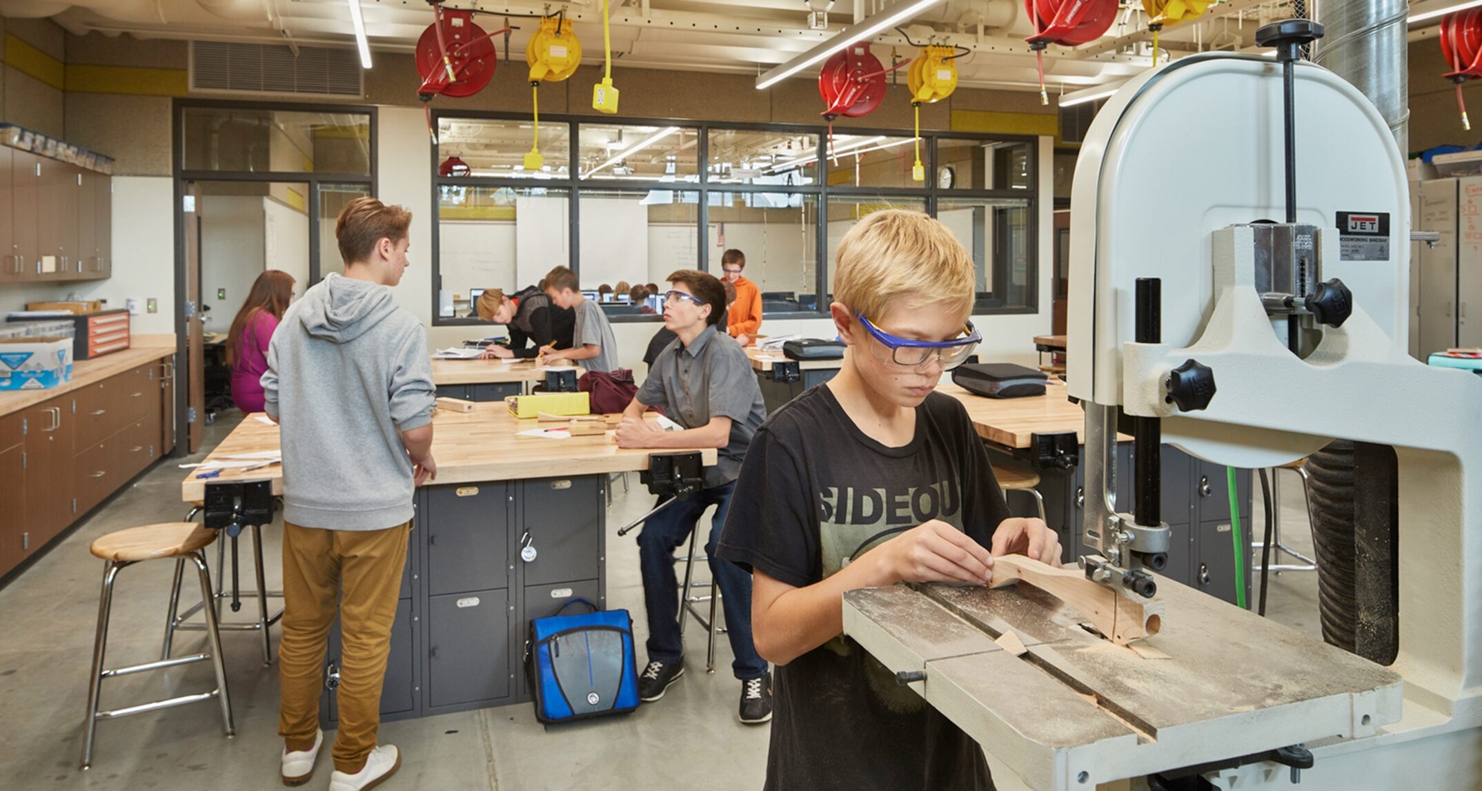 The makerspace at Salk Middle School features complementary spaces for making. A shop, or “dirty” making space is supported by a “clean” research space beyond which houses computers, 3D printers, and other supporting devices. – NAC