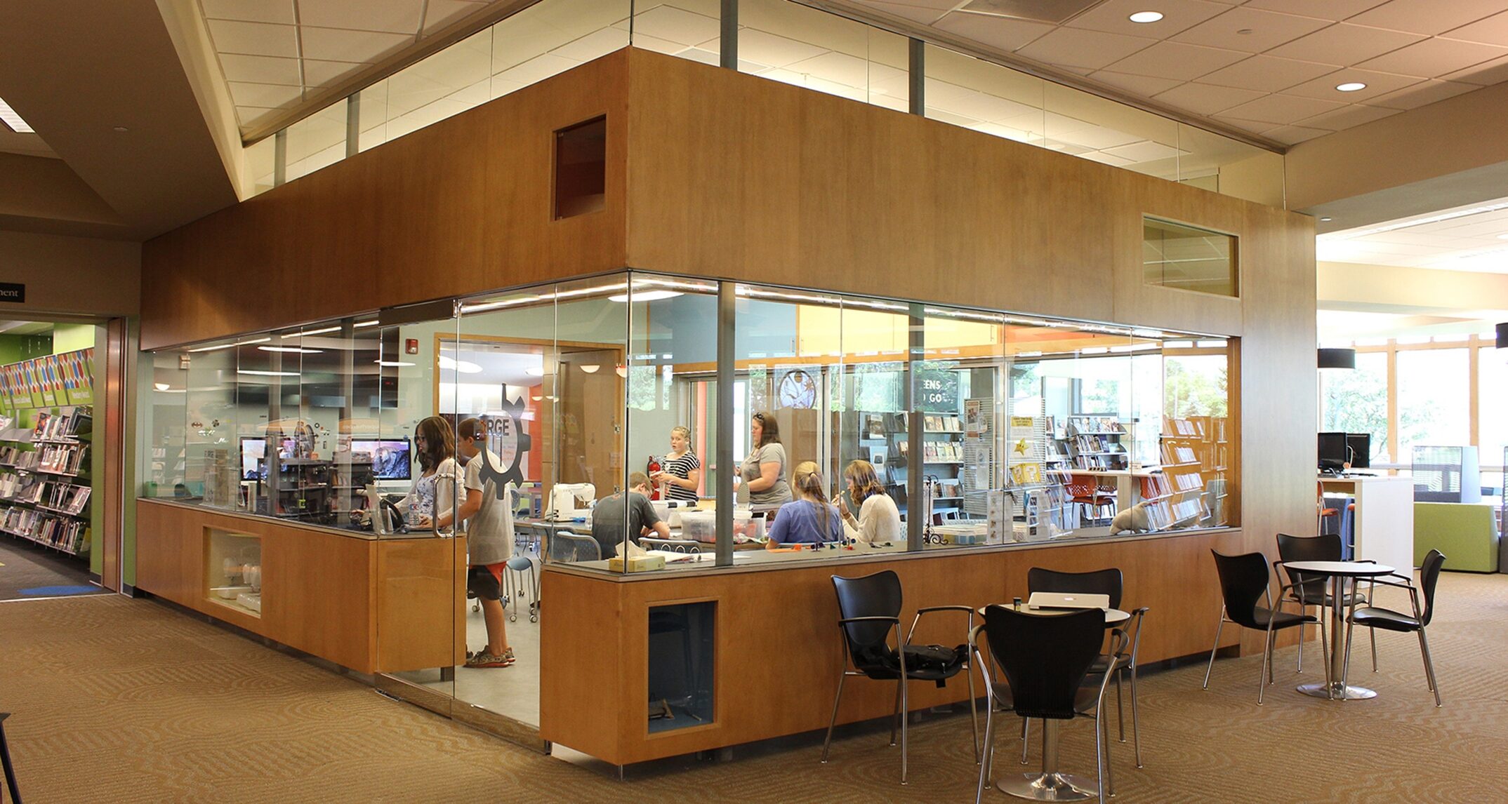 The Forge is an open makerspace within the Ela Public Library that features large expanses of glass to showcase learning and put project work on display. Image courtesy of Demco Interiors
