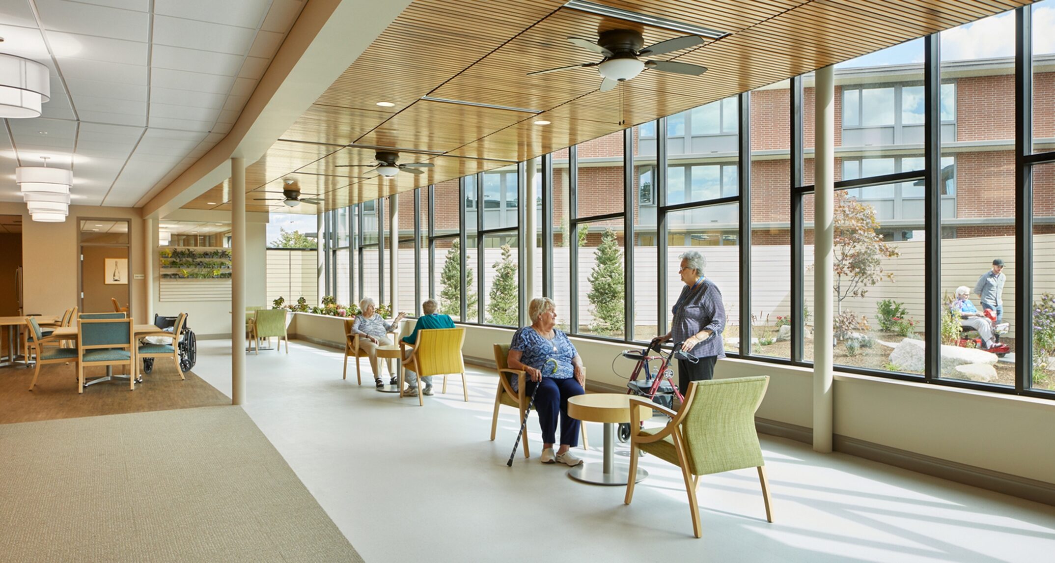 Large windows in the common spaces at Riverview Retirement’s
memory care facility not only increase daylighting, but provide unobstructed
views to an interior garden that both residents and staff regularly enjoy. -
NAC Architecture