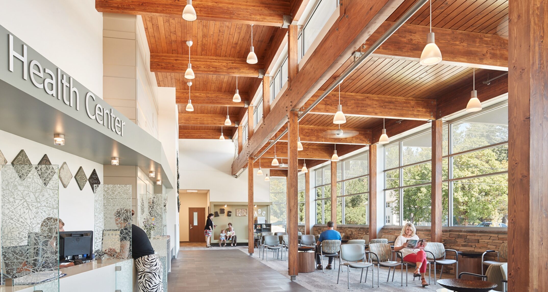 Large windows in the lobby provide a visual connection to nature, while the deliberate use of finishes and patterns serve to mimic the natural environment. Newport Hospital Health Center – NAC Architecture