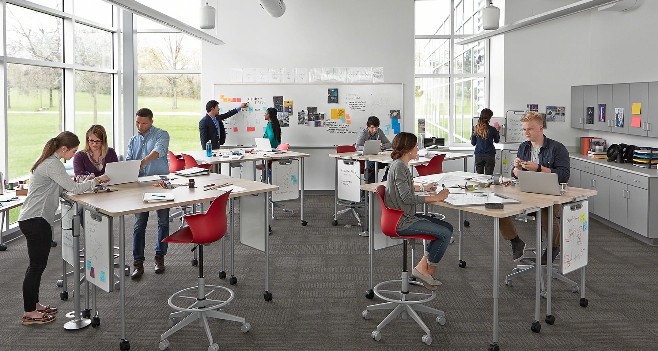 Taller desks give students the option to sit or stand, and facilitates easy movement and collaboration between groups. Image courtesy of Steelcase