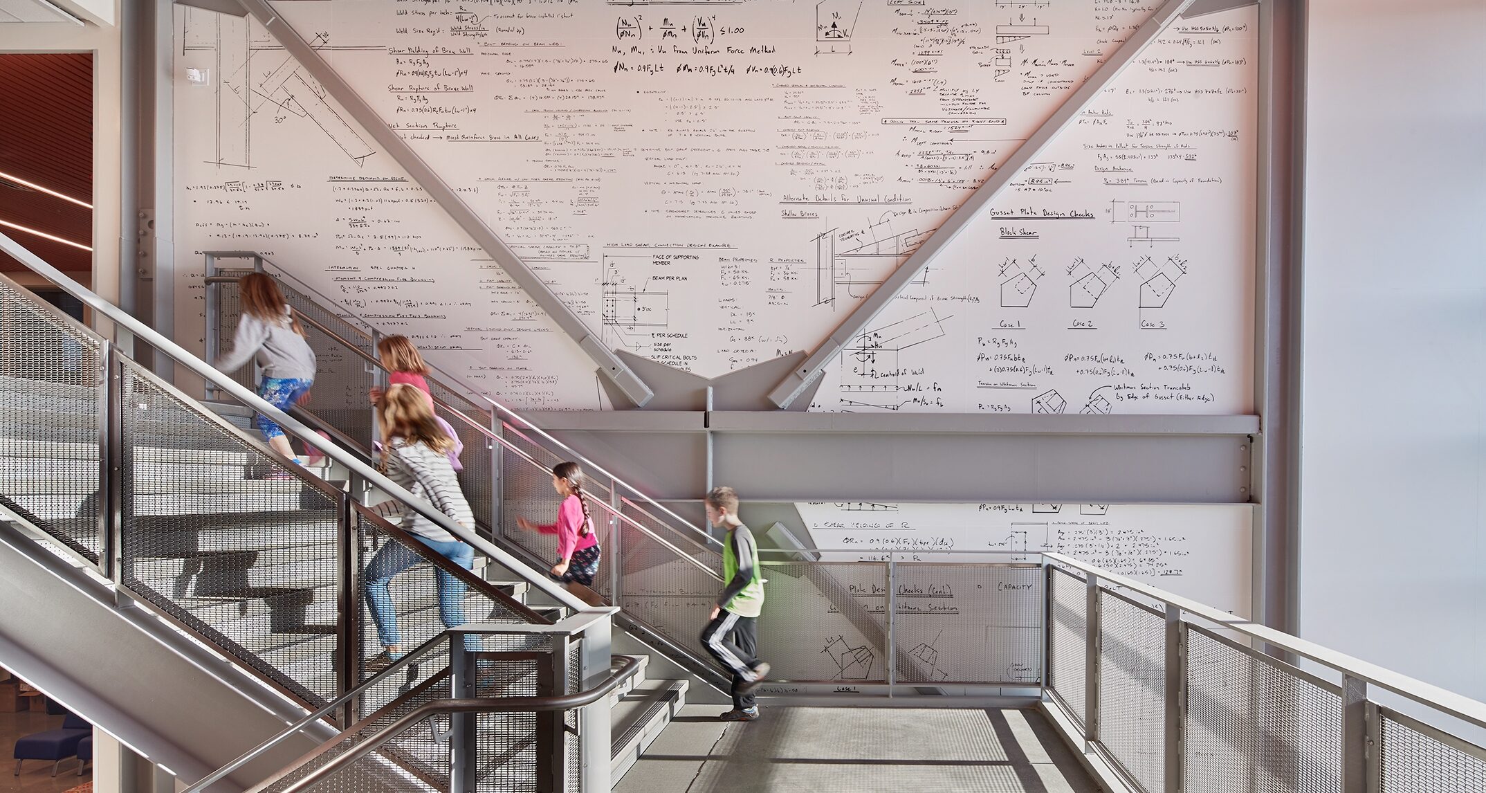 Hazel Wolf’s three-story vertical circulation area features a seismic wall with structural calculations and exposed brace frames. - NAC